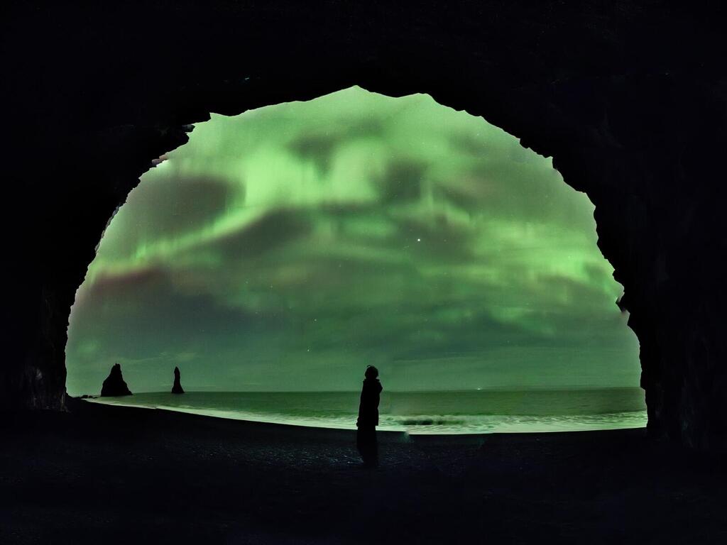 Green sky photographed from inside a cave